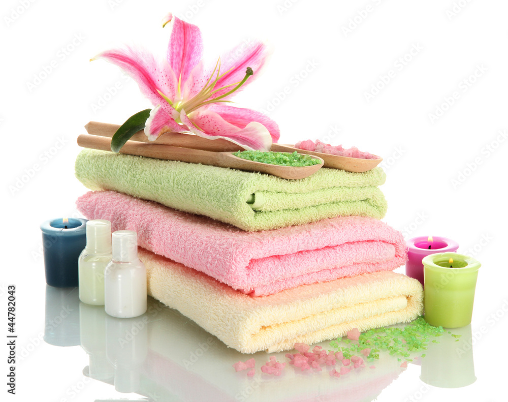 towels with lily, aroma oil, candles and sea salt isolated towels with lily, aroma oil, candles and sea salt isolated