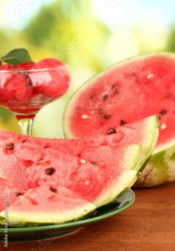 Refreshing desserts of watermelon on green background close-up