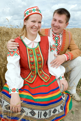 Young man and woman in national dress of the Belarusian.