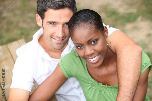 Interracial couple in a park © auremar
