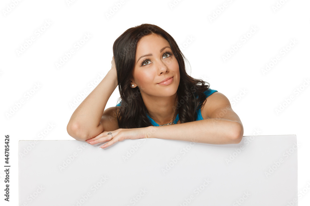 Pensive woman standing leaning on white board Pensive woman standing leaning on white board