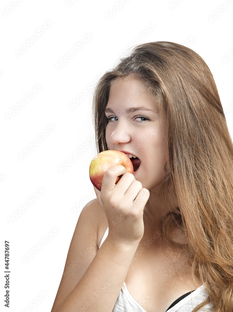 Portrait of an attractive young woman with an apple against whit Portrait of an attractive young woman with an apple against whit