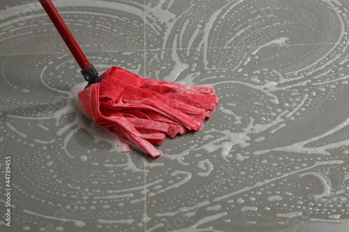 Mopping the floor tiles photo