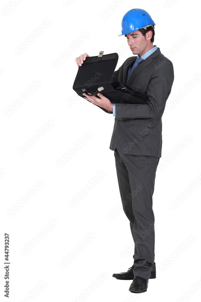 Businessman with a hardhat and a briefcase Businessman with a hardhat and a briefcase