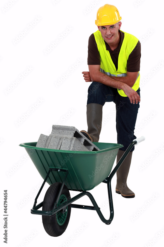 Labourer transporting concrete blocks Labourer transporting concrete blocks