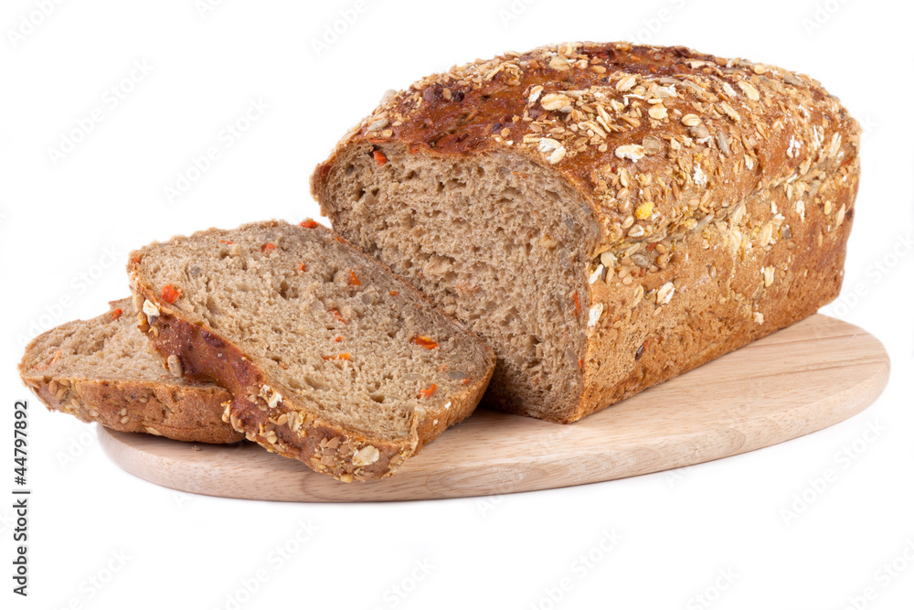 carrot bread on wooden cutting board, isolated on white