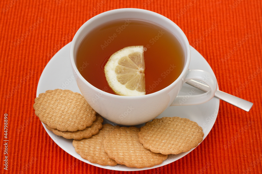 a cup of tea with lemon and cookies a cup of tea with lemon and cookies