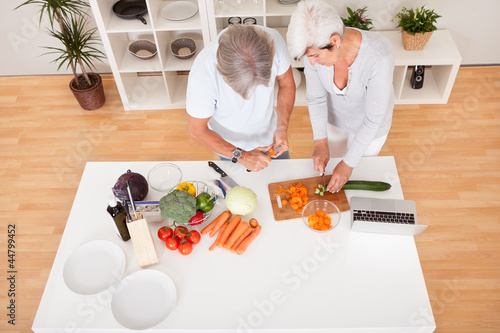 Middle-aged couple preparing a meal