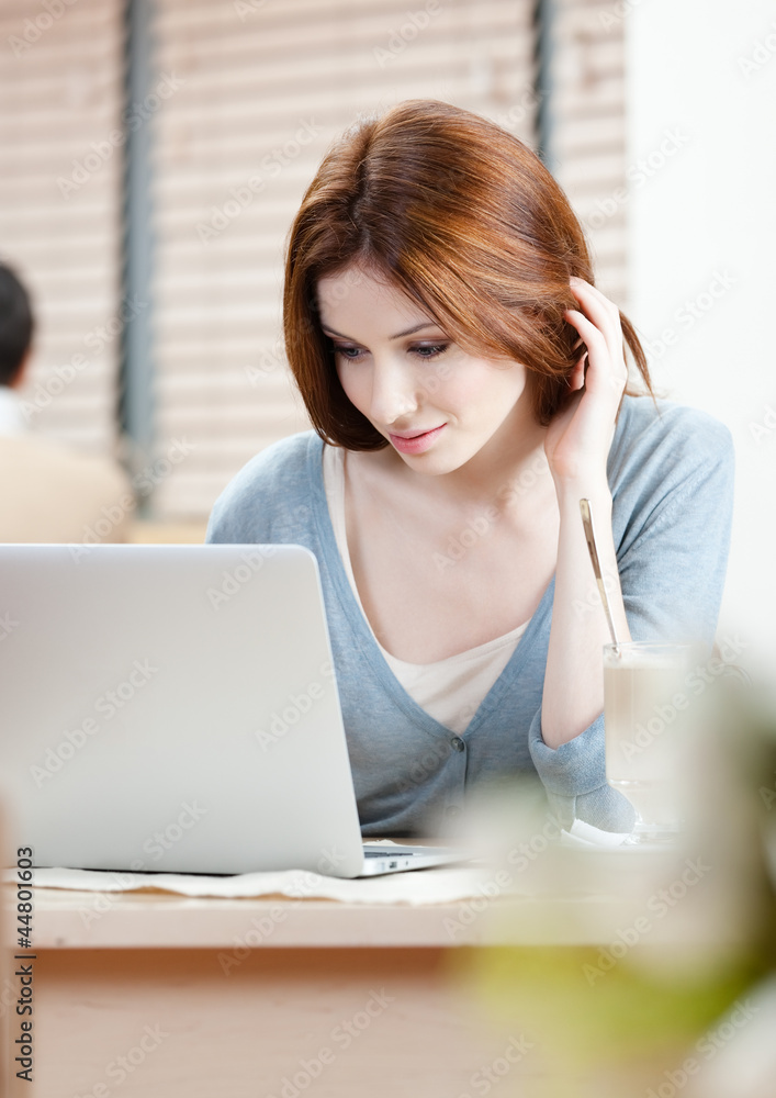 Woman is surfing on the internet on the personal computer Woman is surfing on the internet on the personal computer