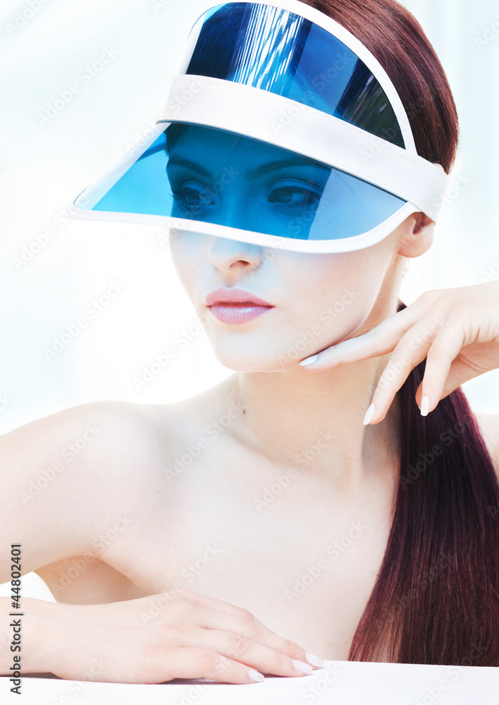 Portrait of attractive young adult woman with sun visor Portrait of attractive young adult woman with sun visor