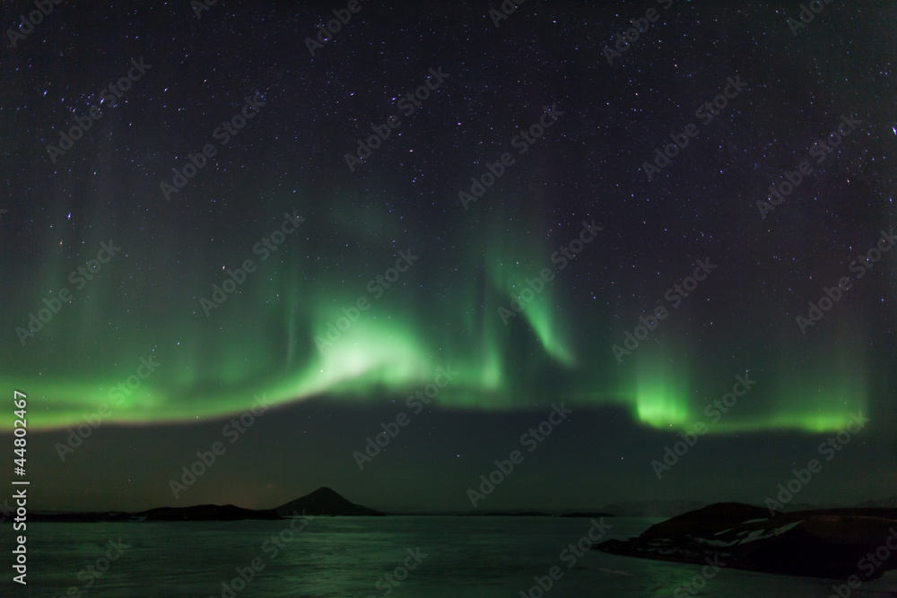 Northern lights over frozen lake Myvatn in Iceland
