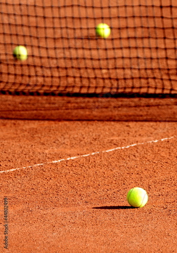 Tennis balls on a tennis clay court © Hayati Kayhan