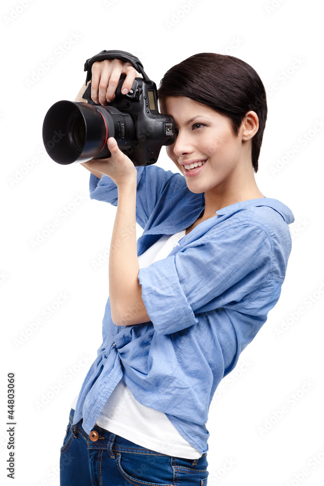 Woman takes images holding photographic camera Woman takes images holding photographic camera
