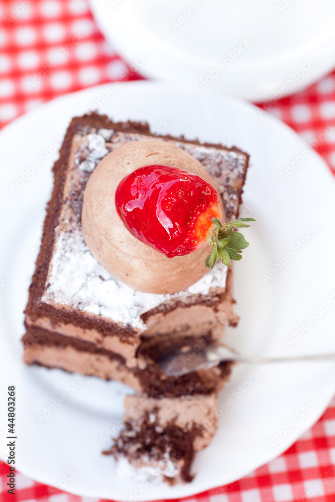 beautiful cake with strawberry and tea on plaid fabric beautiful cake with strawberry and tea on plaid fabric