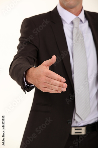 Businessman holding his hand out for a handshake