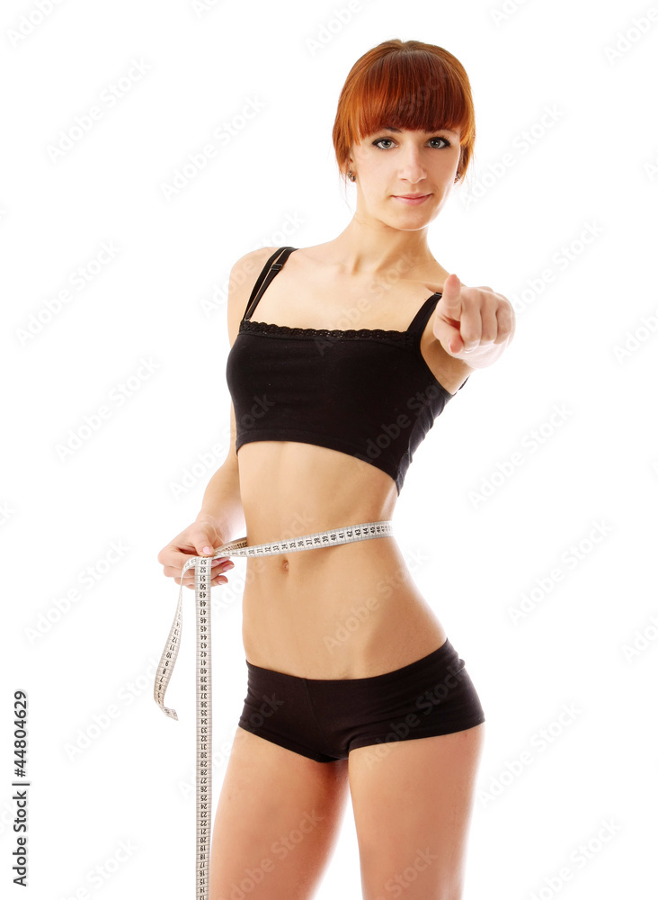 Athletic woman with measure tape pointing at camera Athletic woman with measure tape pointing at camera