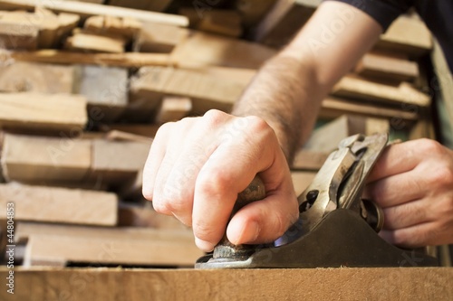 carpenter working  with old plane