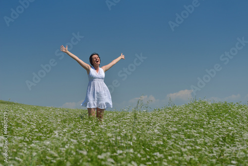 Young happy woman in green field