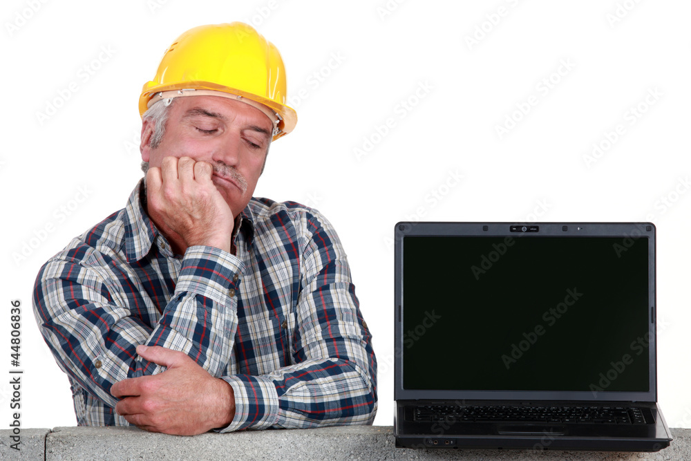 senior craftsman posing next to a laptop senior craftsman posing next to a laptop