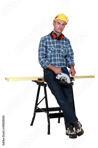 Tradesman standing in front of a workbench