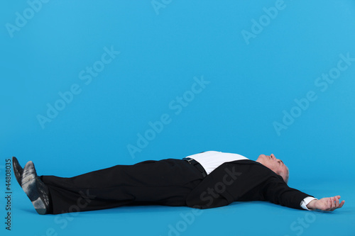Фотография Businessman laying on floor