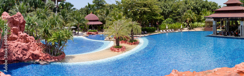 Tropical resort at swimming pool © PinkBlue
