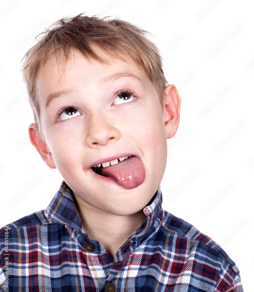 Closeup portrait of a mischief boy showing his tongue Closeup portrait of a mischief boy showing his tongue