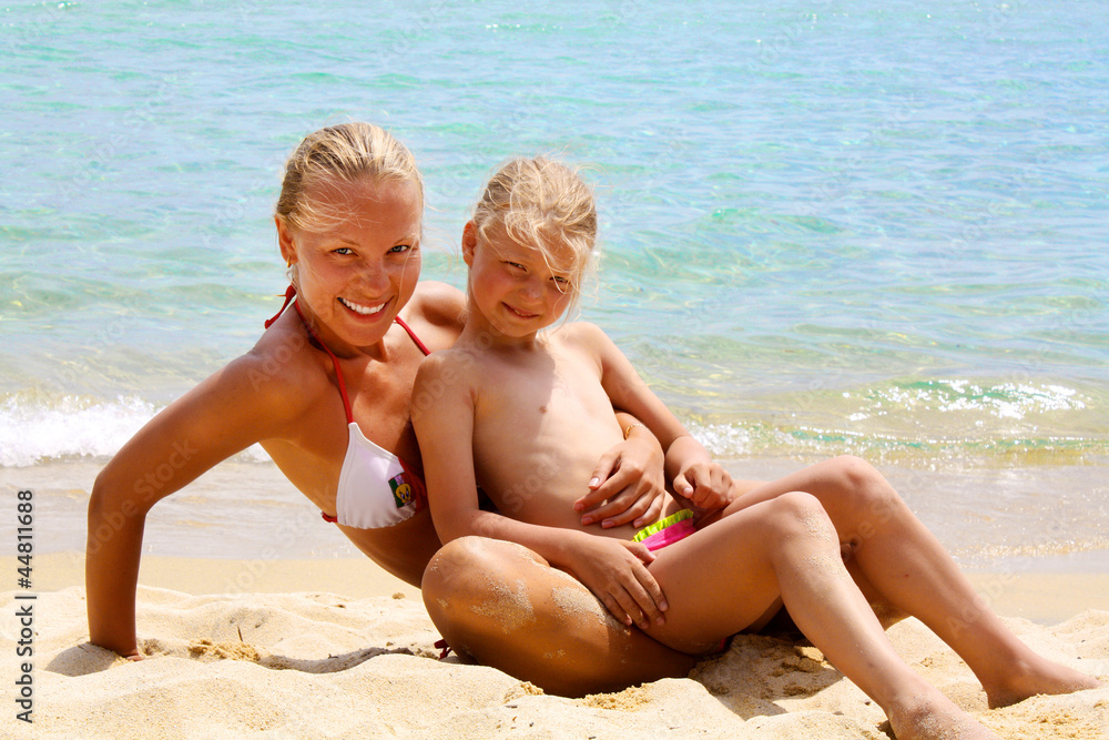 Mother and daughter enjoying summer beach vacation Mother and daughter enjoying summer beach vacation