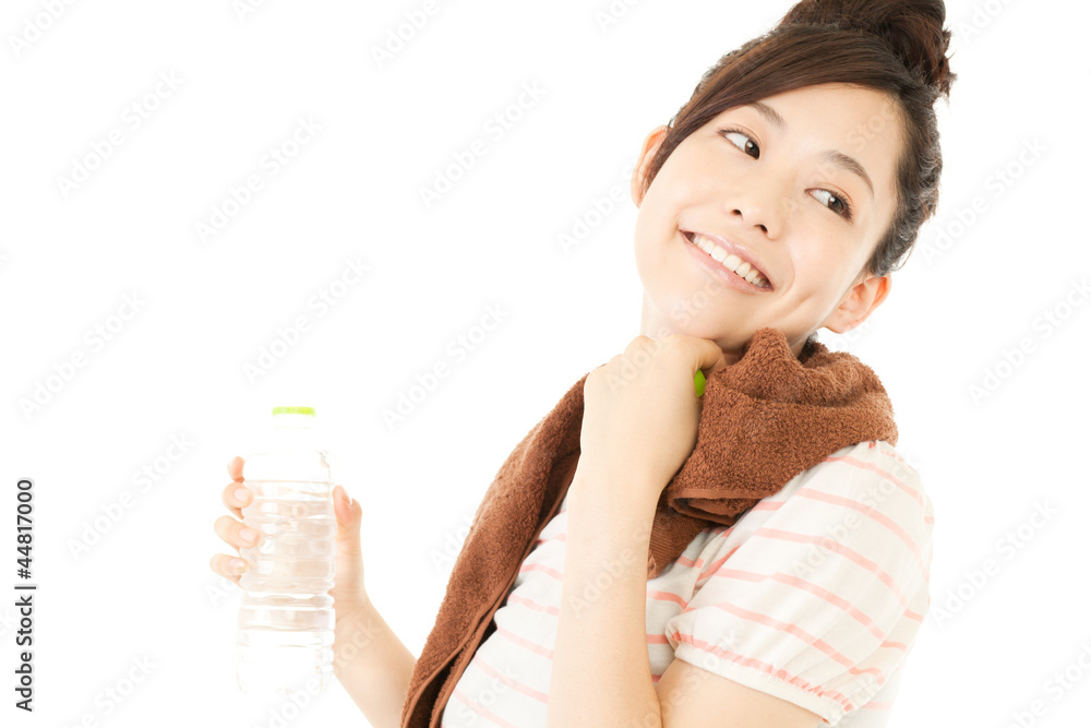 Beautiful young woman drinking water at workout. Portrait of asi Beautiful young woman drinking water at workout. Portrait of asi