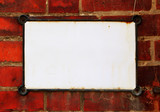 Blank tablet over red brick wall
