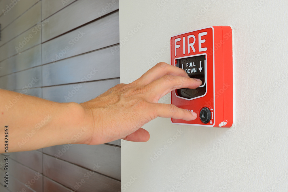 The hand of man is pulling fire alarm The hand of man is pulling fire alarm