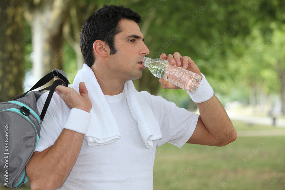 Man drinking water after a workout Man drinking water after a workout