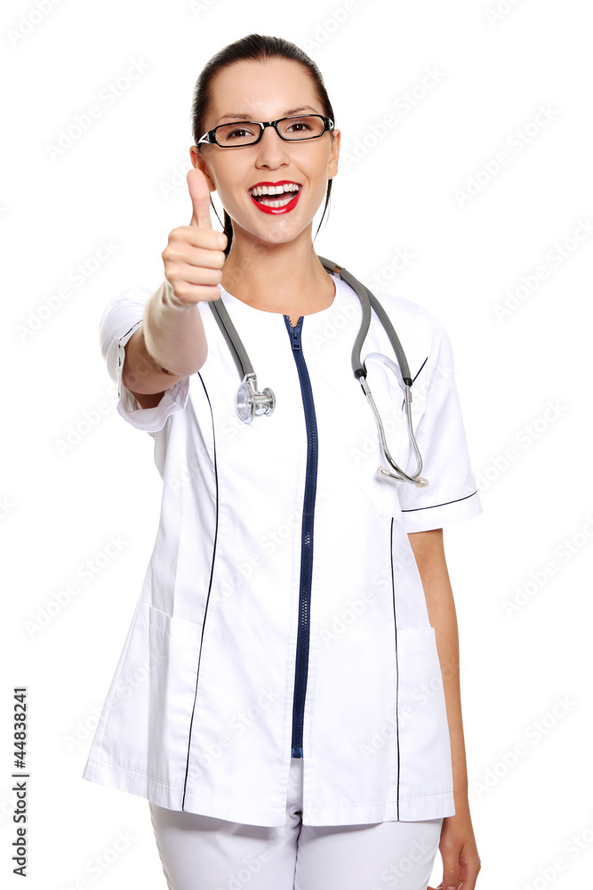 Young female doctor or nurse gesturing OK