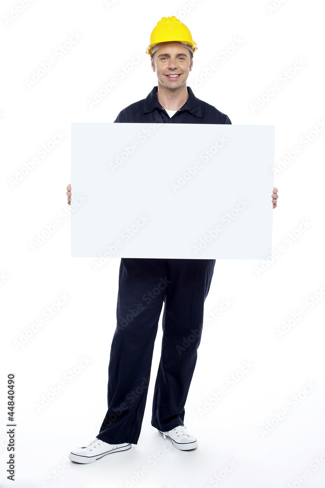 Repairman holding blank billboard, full length portrait Repairman holding blank billboard, full length portrait
