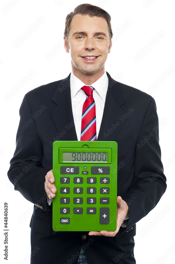 Young businessman showing big green calculator Young businessman showing big green calculator