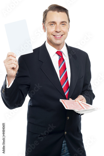 Executive showing blank playing card to camera