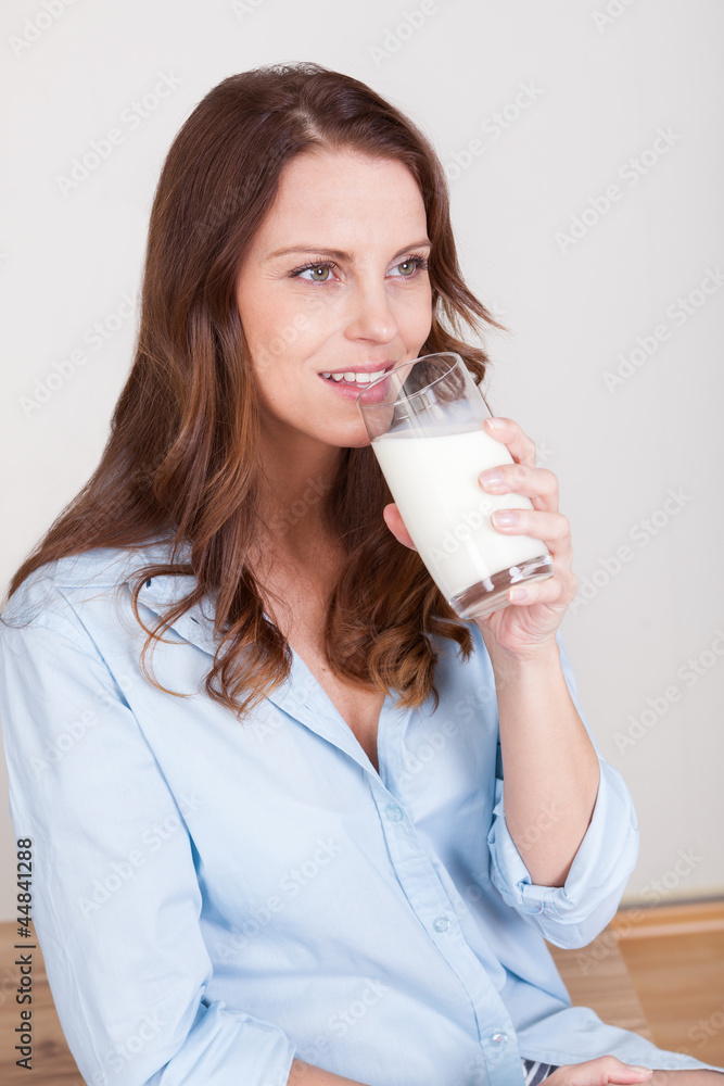 Woman drinking a glass of milk Woman drinking a glass of milk
