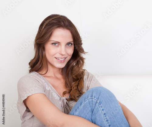 Casual woman sitting on a couch