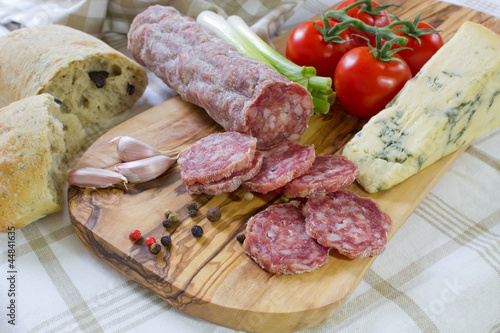 French saucisson with cheese on cutting board