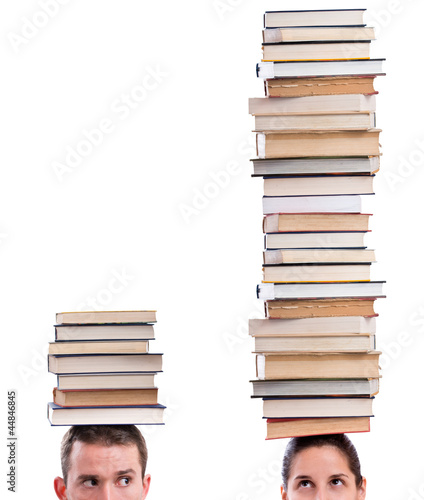 Man and woman holding books on their heads