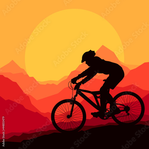 Mountain bike rider in wild mountain nature landscape background