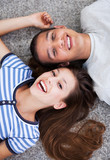 Happy young couple lying down
