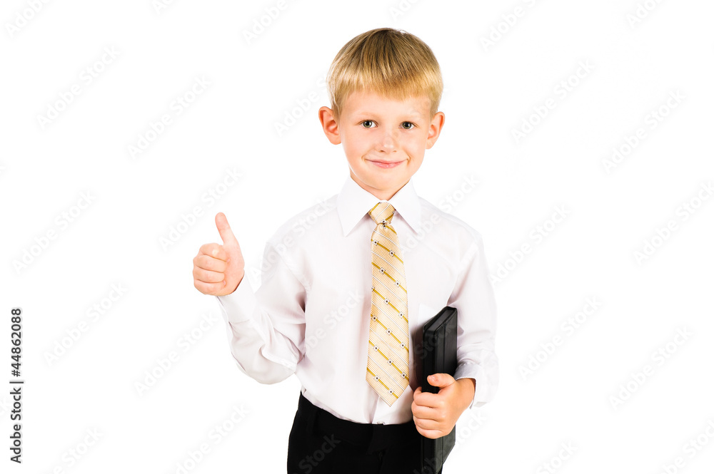 Portrait of a smiling schoolboy holding pad with thump up sign i Portrait of a smiling schoolboy holding pad with thump up sign i