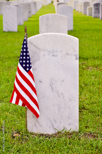 row of tombstones with an american flag
