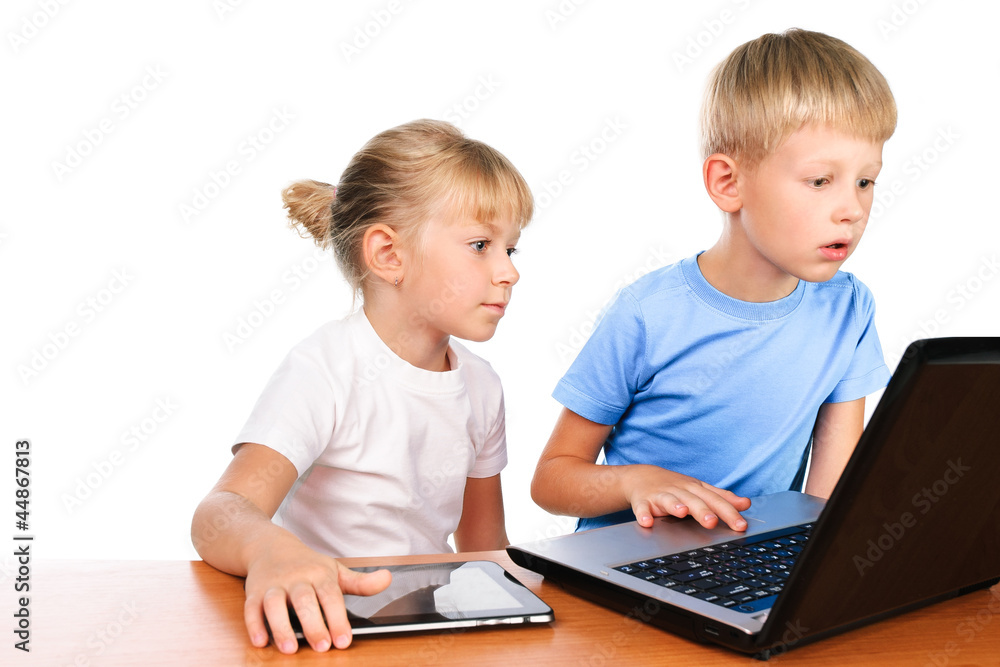 overwhelmed elementary boy and girl sitting at table using digi overwhelmed elementary boy and girl sitting at table using digi