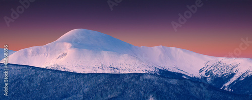 Panorama of snowy summit at winter morning. Hoverla, Ukraine