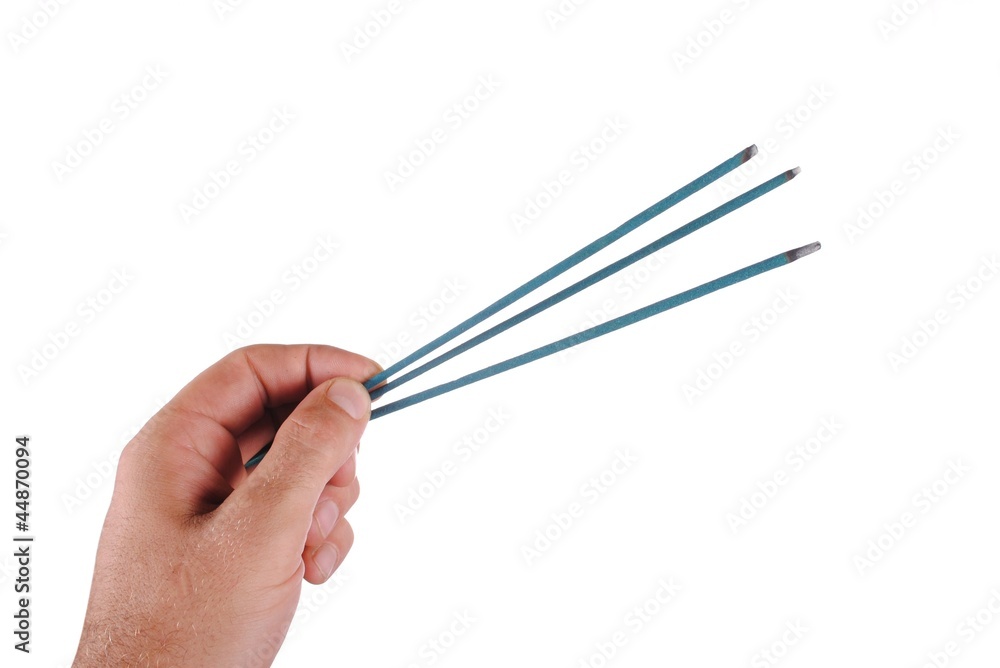 hand holds three joss sticks, isolated on white hand holds three joss sticks, isolated on white