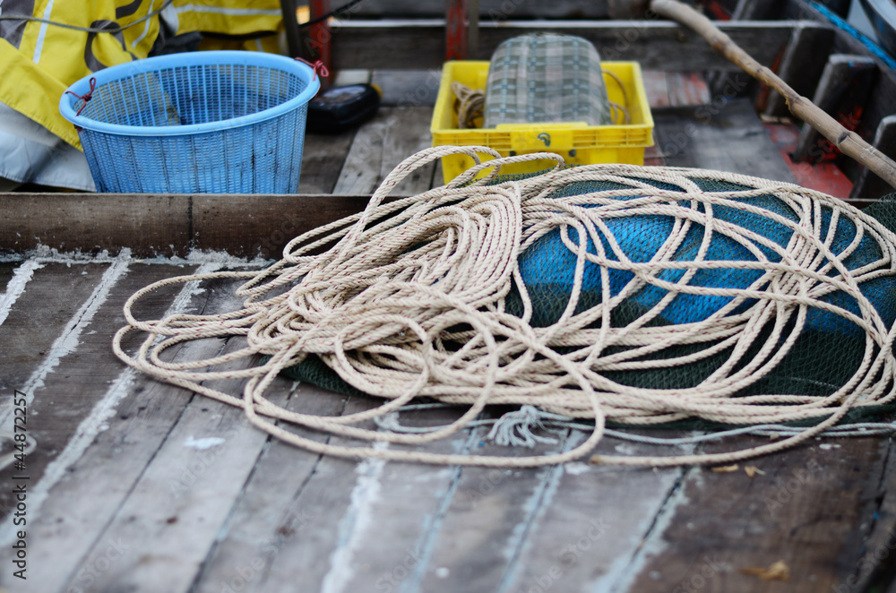 Rope on wooden floor of the fisherman boat.