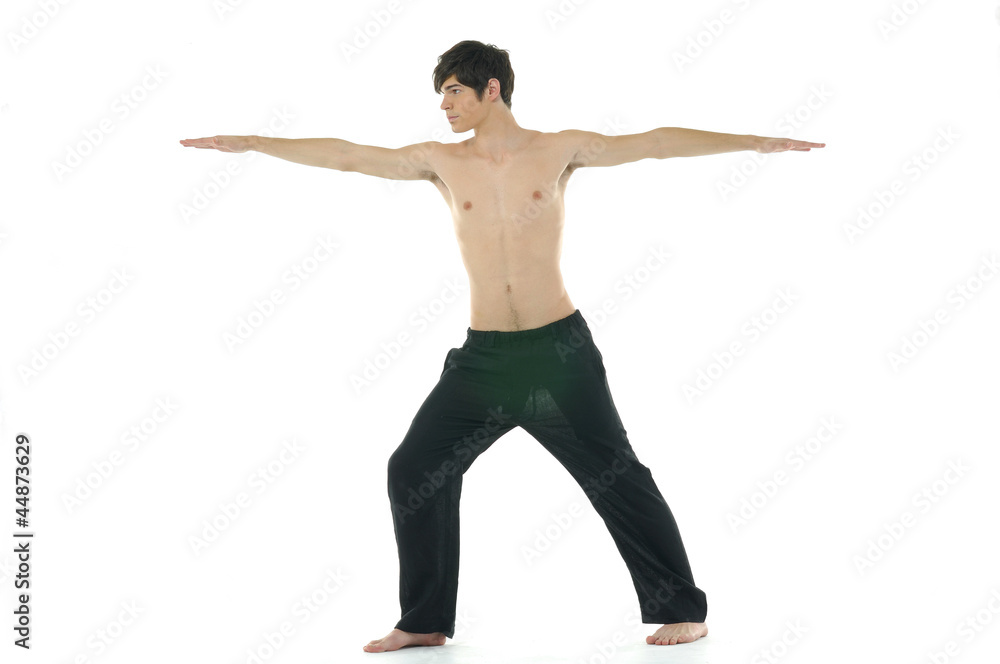 Young man doing yoga in the room