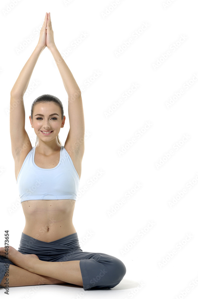 Young woman doing yoga moves or meditating on white Young woman doing yoga moves or meditating on white